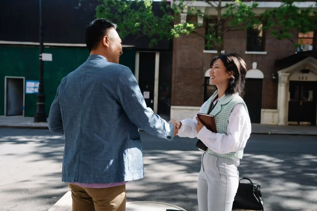 Professionals meeting and shaking hands during a business networking event in Singapore